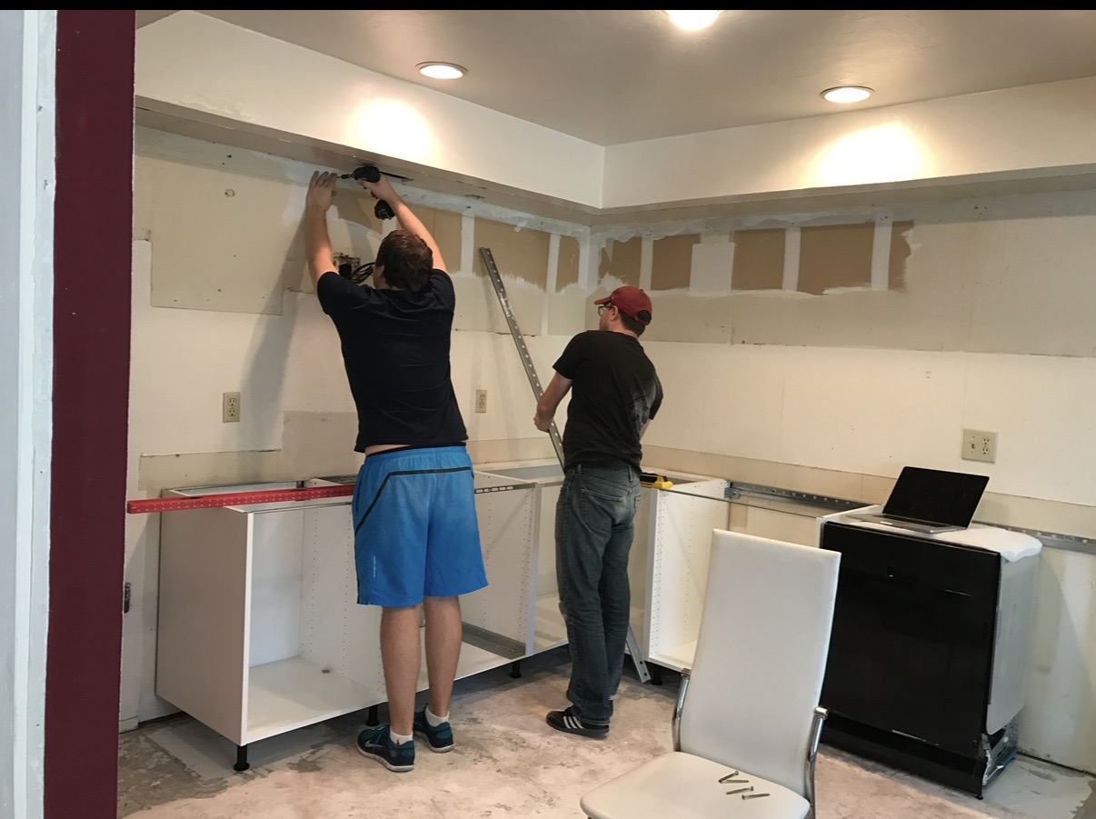 Kitchen cabinetry being installed during construction